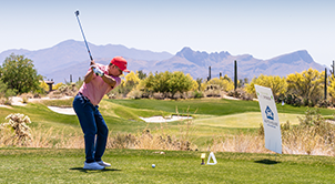 Man preparing to swing at golf.